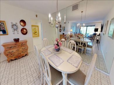 Just Steps to the Sandy Beach from this Two Bedroom Condo